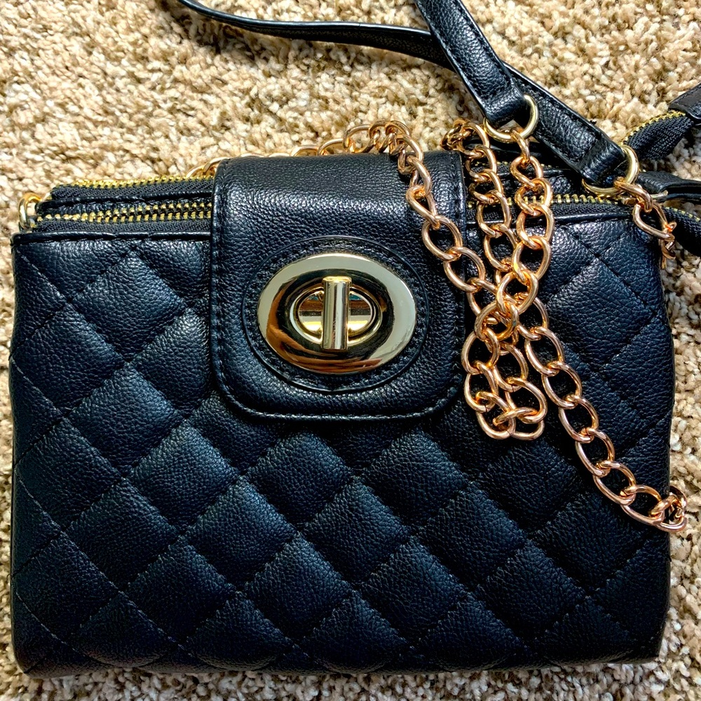 Ladies black shoulder bag with gold chain strap.